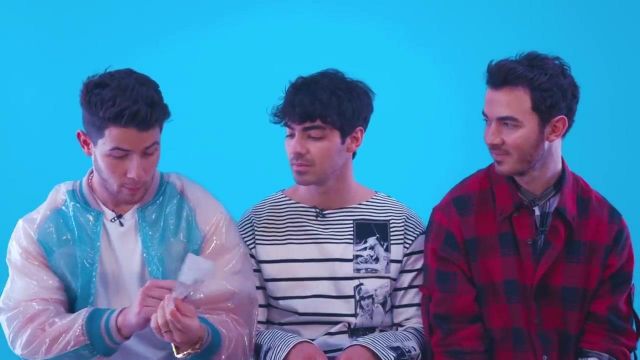 Blue plastic-like jacket worn by Nick Jonas in "How many weddings is too many?" The Jonas Brothers get sassy as they "Answer the Internet" YouTube video