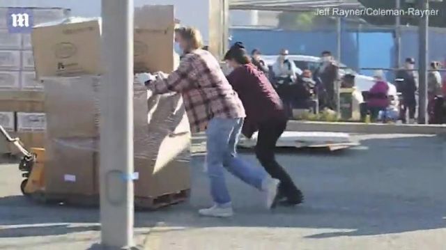 White canvas shoes of Brad Pitt in Brad Pitt unloading and handing out boxes of groceries
