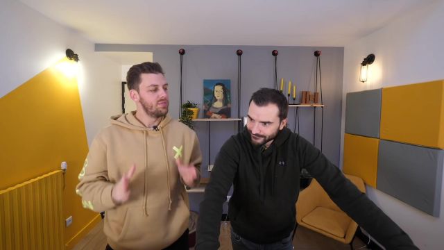 Le hoodie beige avec une croix jaune et une écriture sur l'arrière de la manche porté par Pierre Croce dans sa vidéo YouTube Une nuit sur un lac (dans un château gonflable)