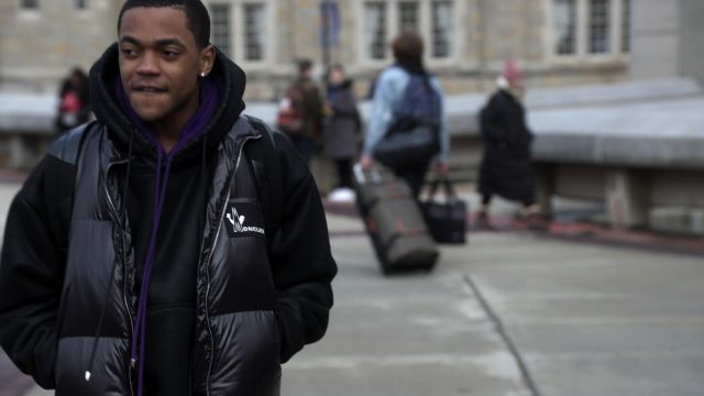 Hoodie mixed with black and purple, a bat logo on it worn by Tariq