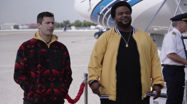 The retro red coat with ethnic pattern worn by Jake Peralta (Andy Samberg) in Brooklyn Nine-Nine (Season 7 Episode 8)