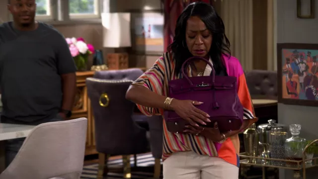 Hermes Purple Handbag held by Tina (Tichina Arnold) in The Neighborhood TV show wardrobe (Season 4 Episode 17)