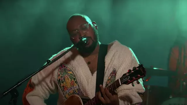 White oversize embroidered sweater worn by Bartees Strange as seen in Jimmy Kimmel Live!