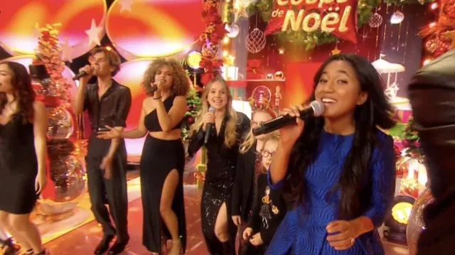 The long black sequin dress worn by Carla Carla Donah in the show Les 12 Coups de Noël on Saturday, December 24, 2022