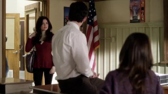 The red vest with flared neckline on the bottom worn by Aria Montgomery (Lucy Hale) in the series Pretty Little Liars (S01E19)