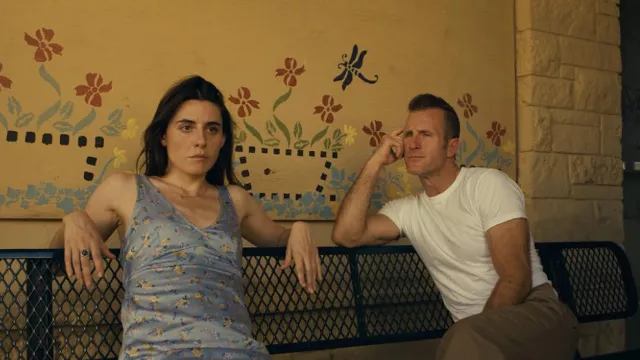 Blue silk printed dress worn by Lola Brisky (Marianne Rendón) as seen in One Day as a Lion movie