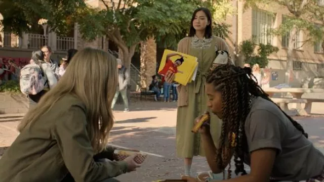 The green dress with buttons and bow, floral shirt and beige vest worn ...