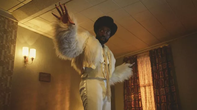 Fur jacket and white suit worn by Gaap (Paapa Essiedu) as seen in Black Mirror (S06E05)