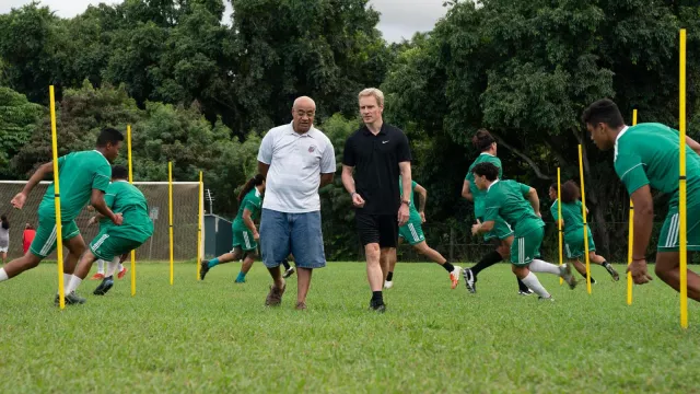 Striped polo shirt worn by Tavita (Oscar Kightley) as seen in Next Goal Wins