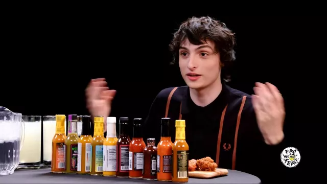 Fred Perry Long Sleeve T-shirt worn by Finn Wolfhard as seen in Hot Ones on February 2024