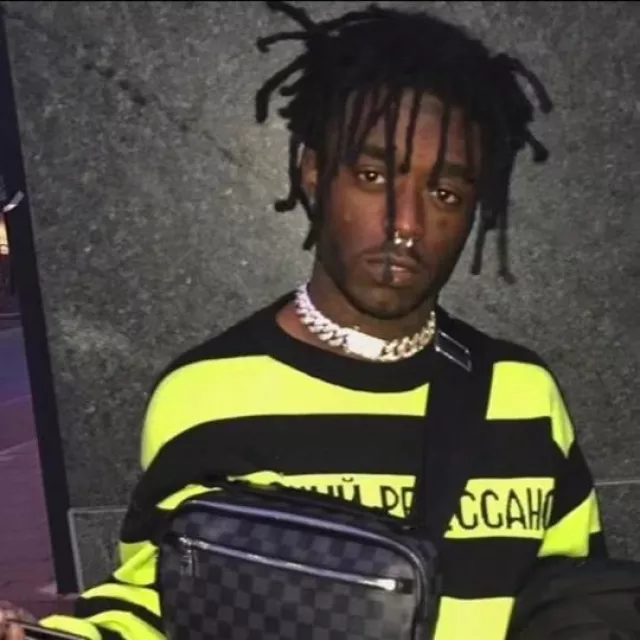 Lil Uzi Vert is wearing Black and neon yellow long striped sleeve top in a old picture