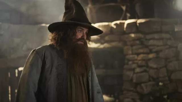 The Lord of the Rings: The Rings of Power Outfits: Tom Bombadil (Rory Kinnear) wears a pointed hat in season 2, episode 6 of the TV series